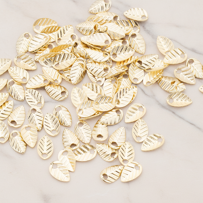 Half Fold Tiny Leaf Charm, 20 Pc on warm marble background (PD.222)