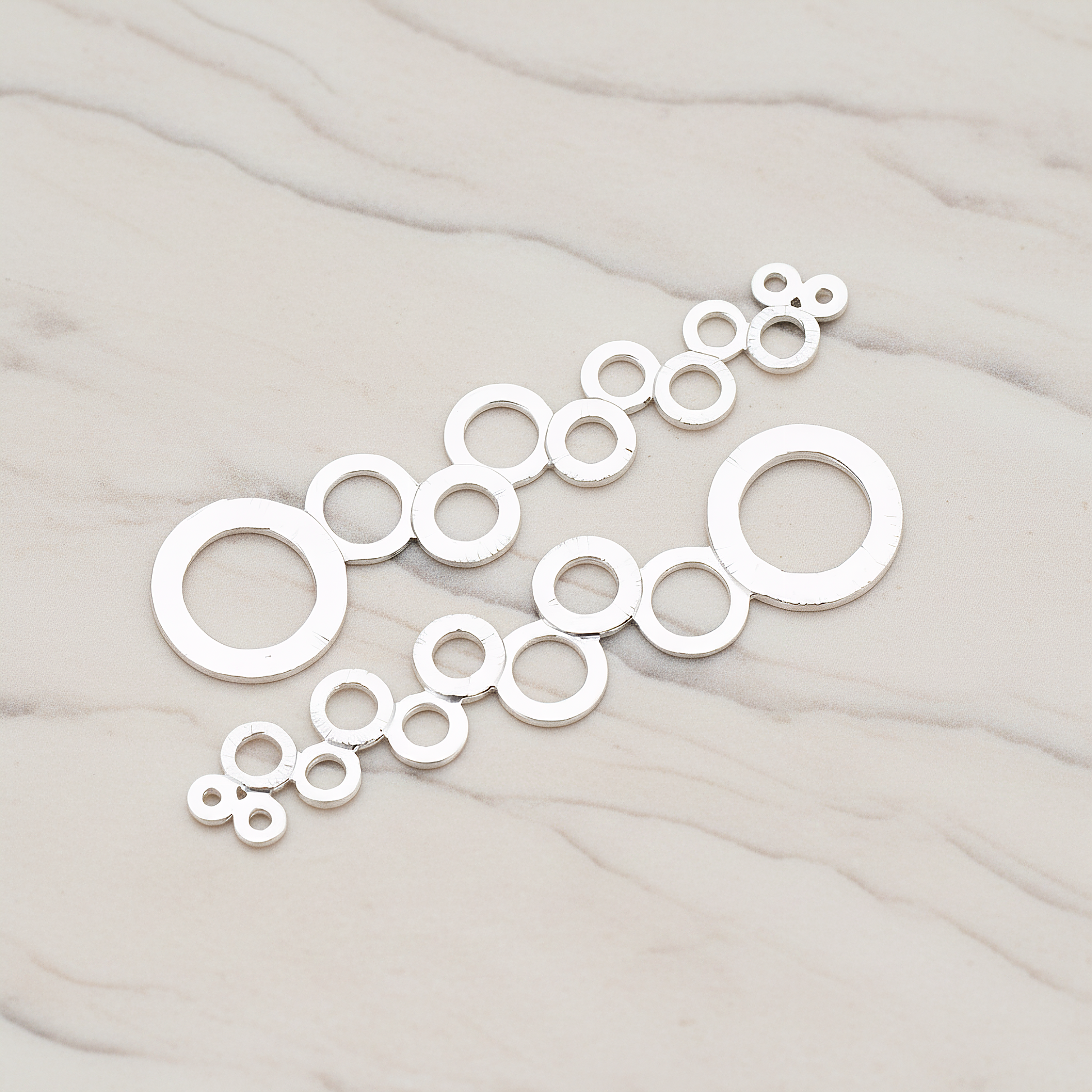 Brushed Multi Circle Stream Pendant, 2 Pc on warm marble background (PD.318-05)