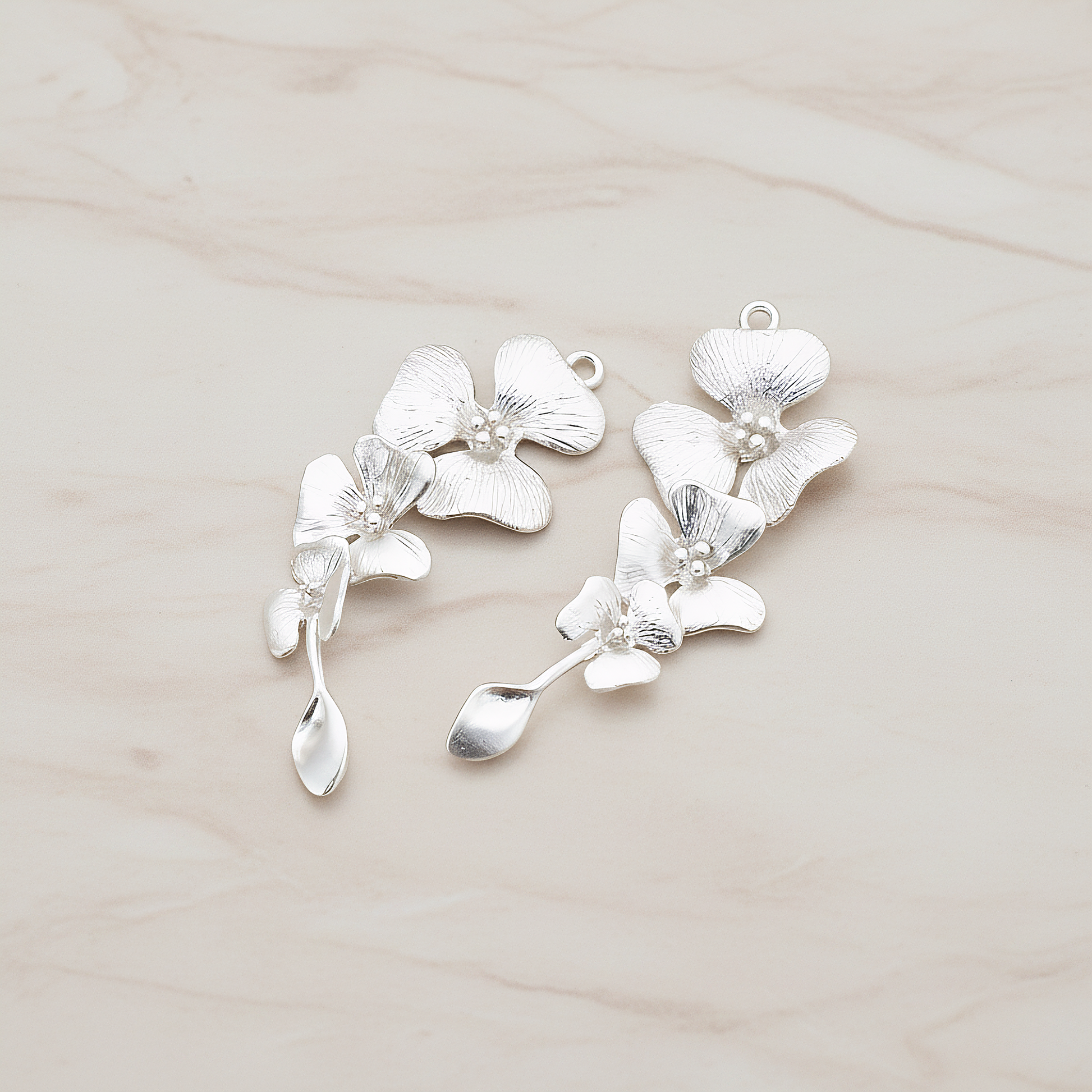 Triple Flower with Tail Pendant, 2 Pc on warm marble background (PD.377)