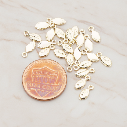 Xsmall Tiny Leaf Charm Pendant, 8 Pc on warm marble background (PD.388)