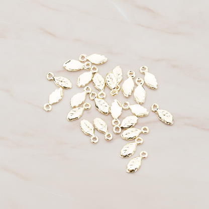 Xsmall Tiny Leaf Charm Pendant, 8 Pc on warm marble background (PD.388)
