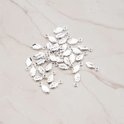 Xsmall Tiny Leaf Charm Pendant, 8 Pc on warm marble background (PD.388)
