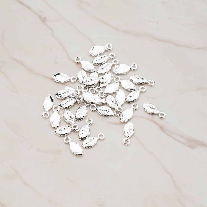 Xsmall Tiny Leaf Charm Pendant, 8 Pc on warm marble background (PD.388)