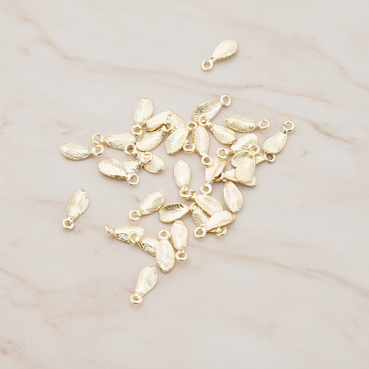 Tiny Leaf Charm Pendant, 8 Pc on warm marble background (PD.426)