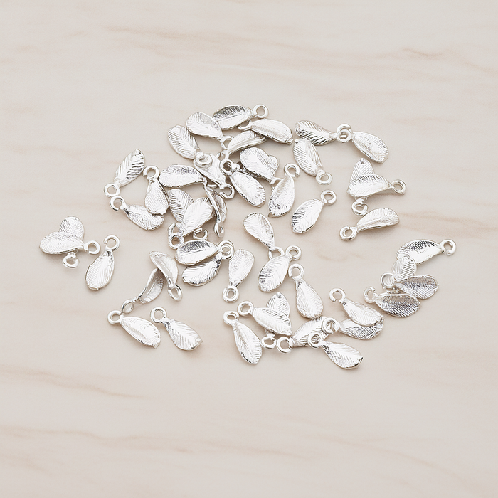 Tiny Leaf Charm Pendant, 8 Pc on warm marble background (PD.426)