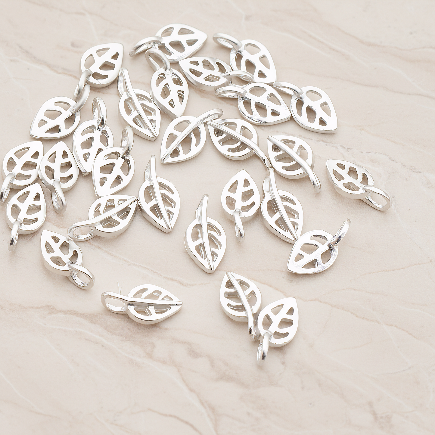 Mini Leaf Pendant, 4 Pc on warm marble background (PD.606)