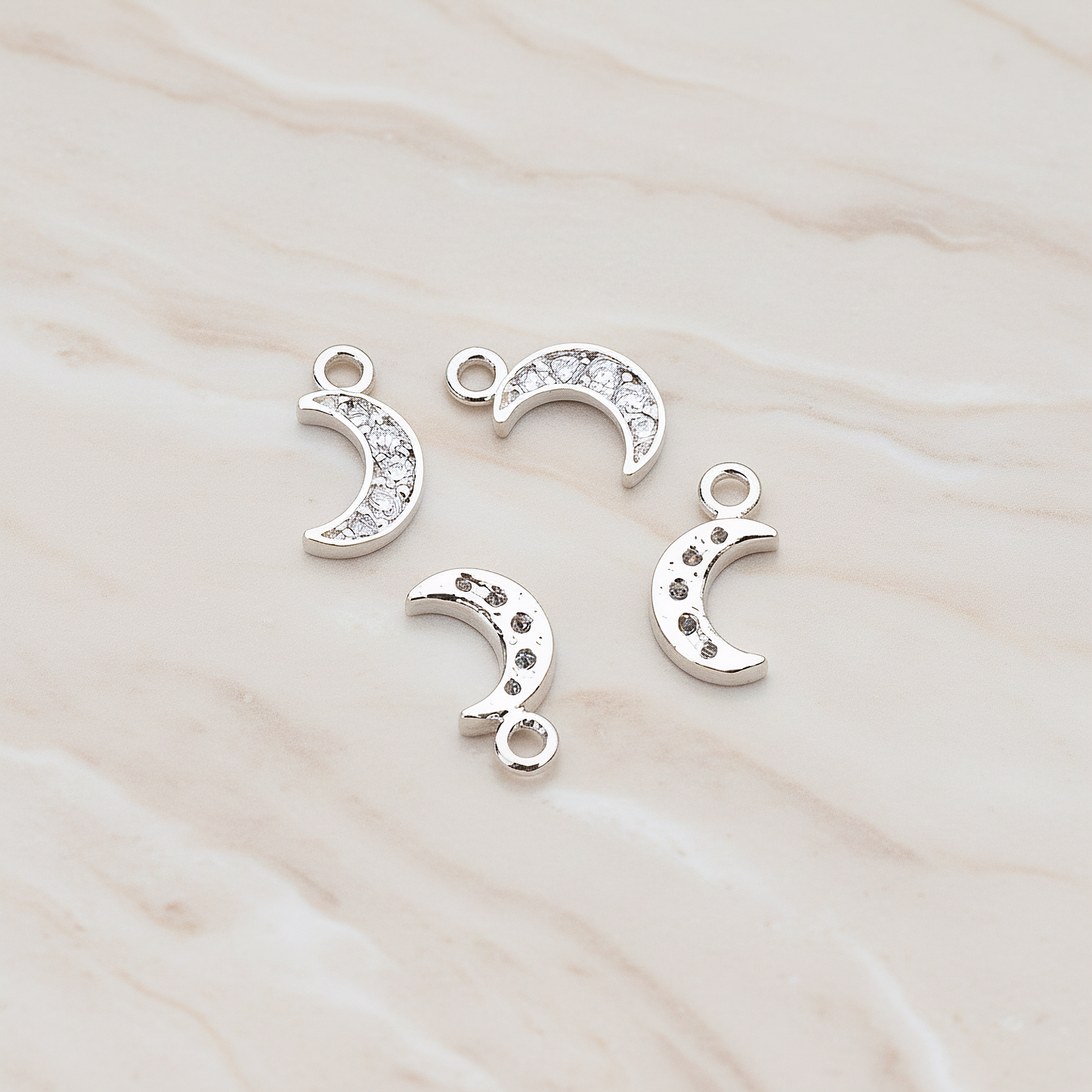 Clear Crystal Cubic Zirconia Setting Crescent Moon Pendant, 2 Pc on warm marble background (PD.750)