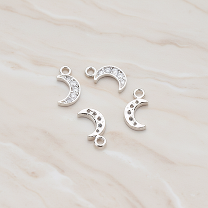 Clear Crystal Cubic Zirconia Setting Crescent Moon Pendant, 2 Pc on warm marble background (PD.750)