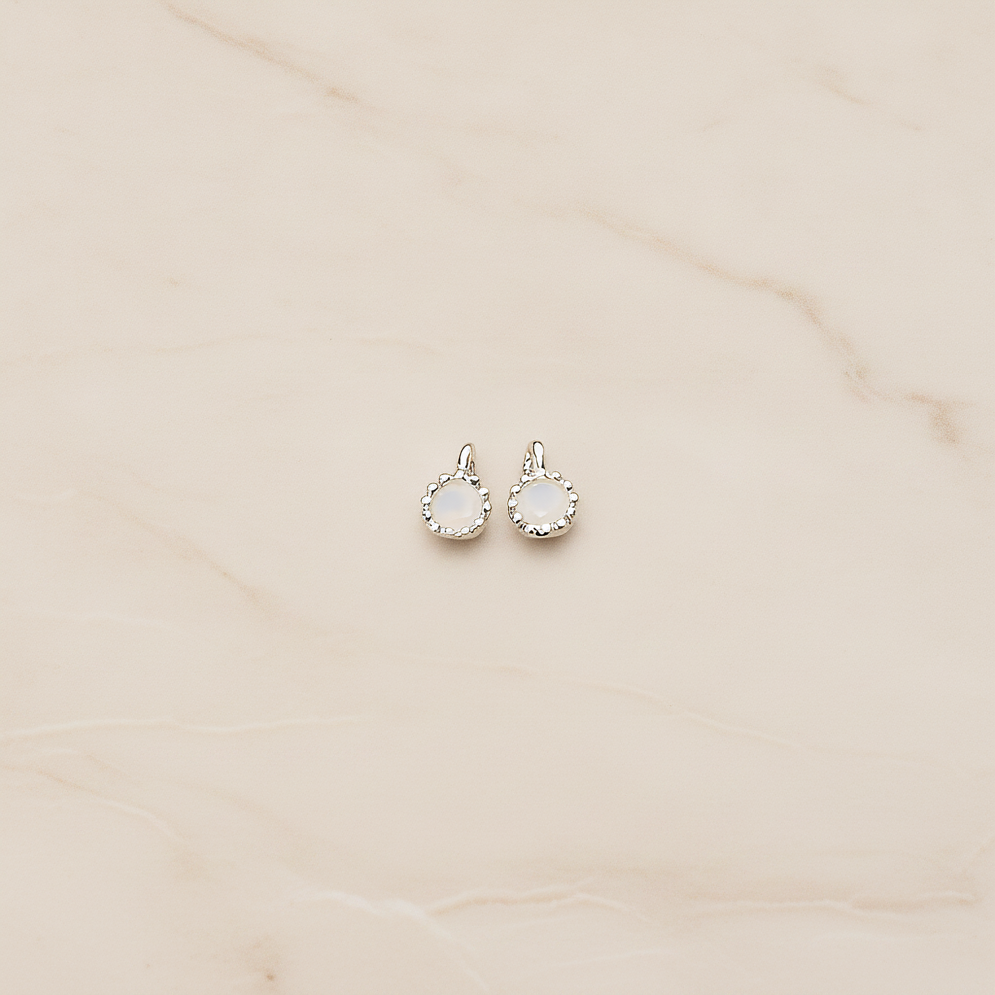 Cubic Zirconia Textured Framed Charm Pendant, 2 Pc on warm marble background (PD.780)