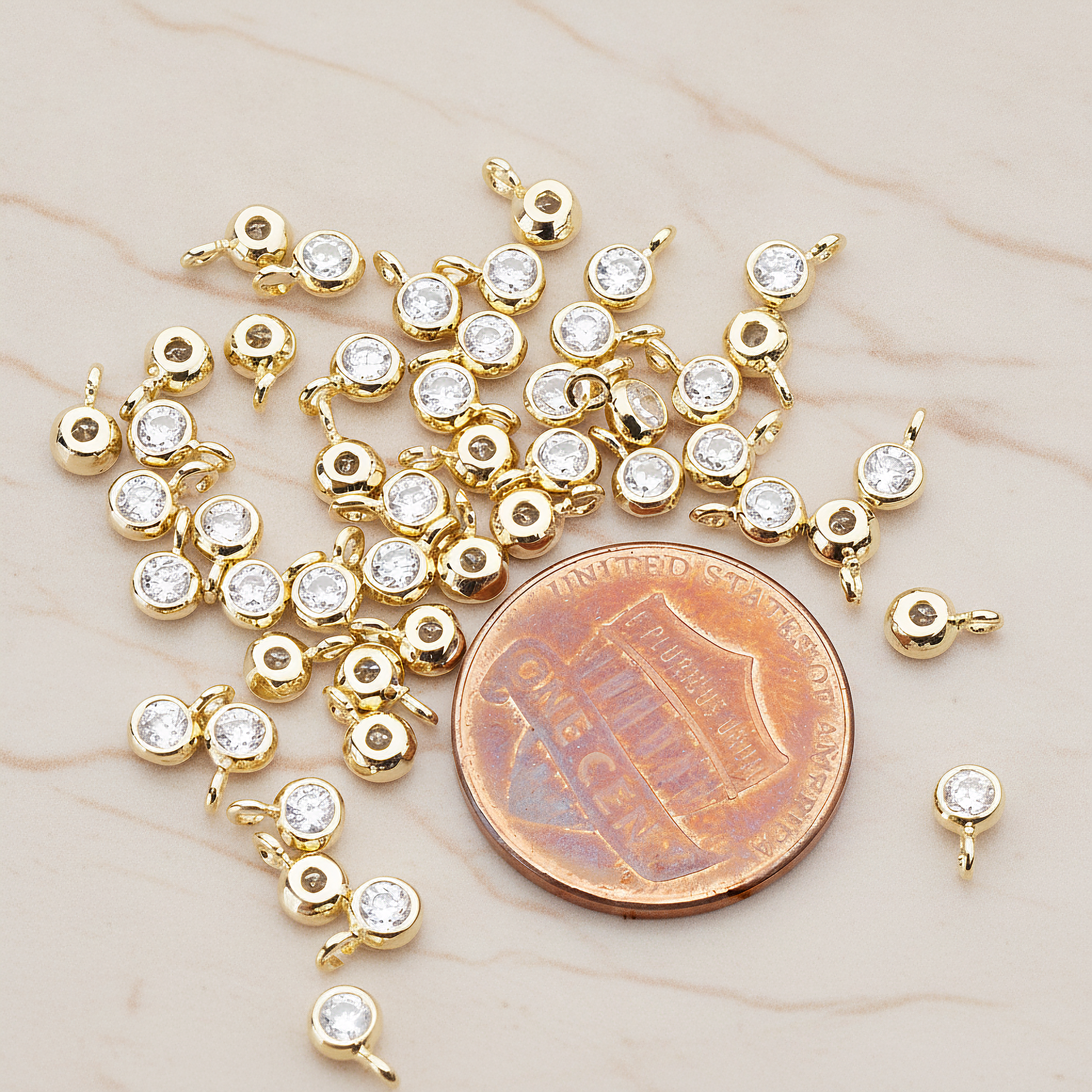 Clear Crystal Cubic Zirconia Round Framed Charm Pendant, 2 Pc on warm marble background (PD.790)