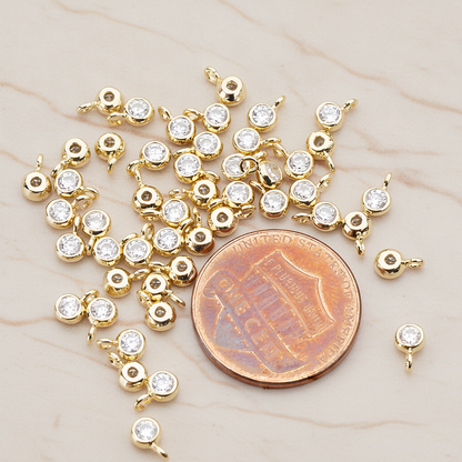 Clear Crystal Cubic Zirconia Round Framed Charm Pendant, 2 Pc on warm marble background (PD.790)